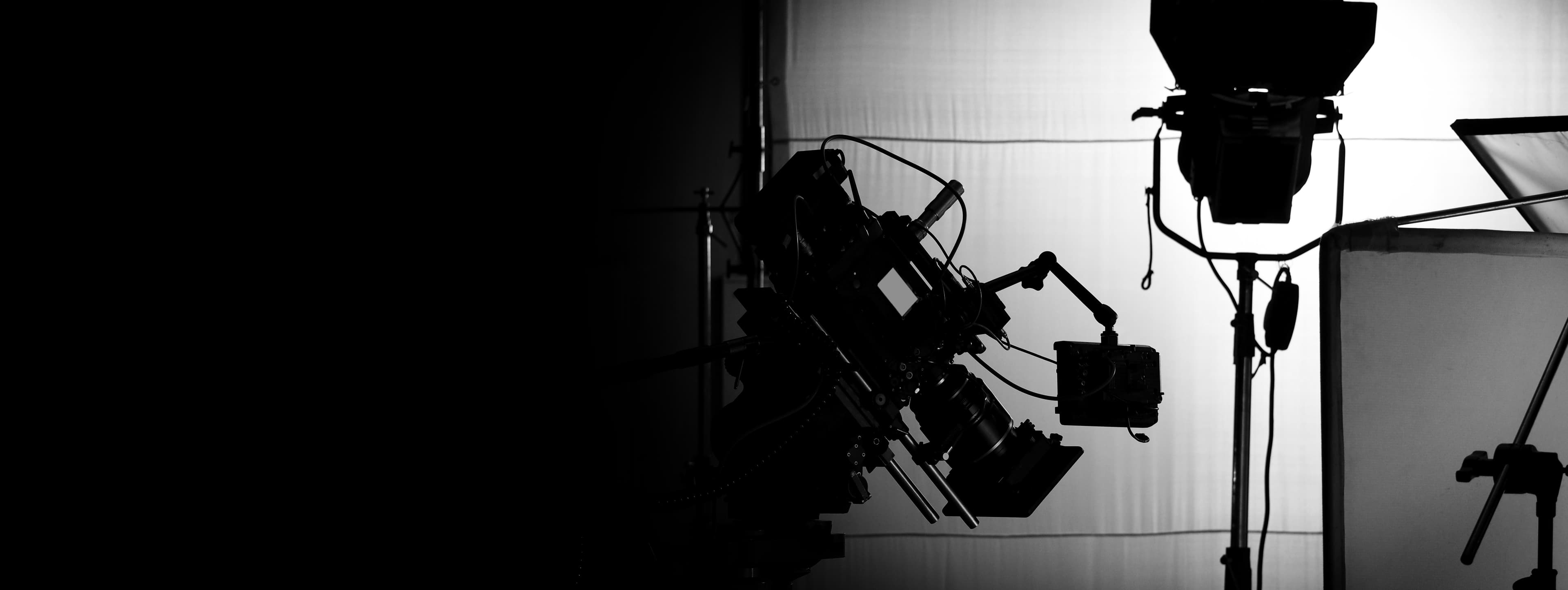 A lighting rig standing on a darkened studio floor