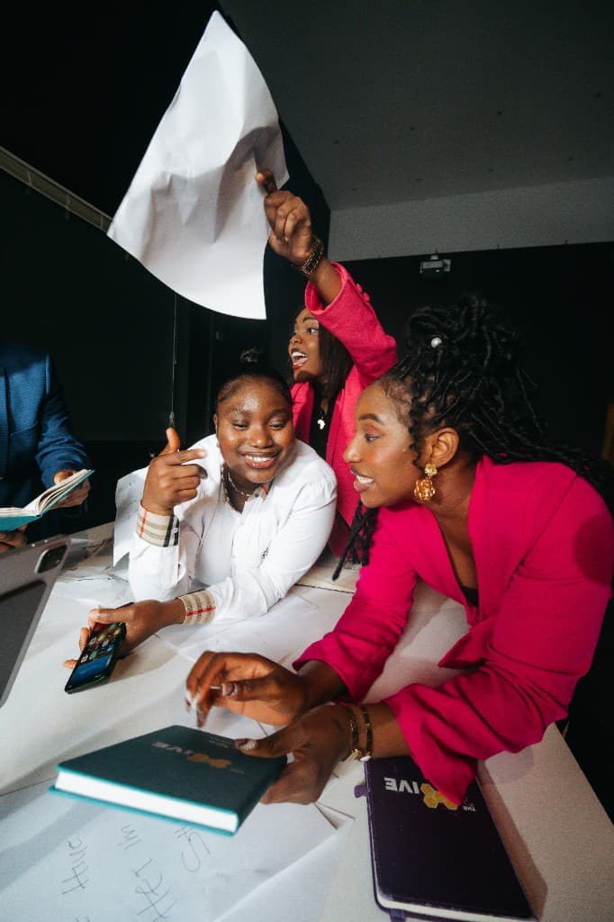 Three colleagues reviewing work together at a table